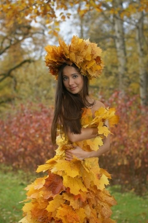 девушка в платье из желтых листьев в парке осенью