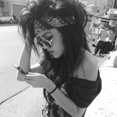 девушка хиппи с мобильным телефоном в круглых очках черно белое фото