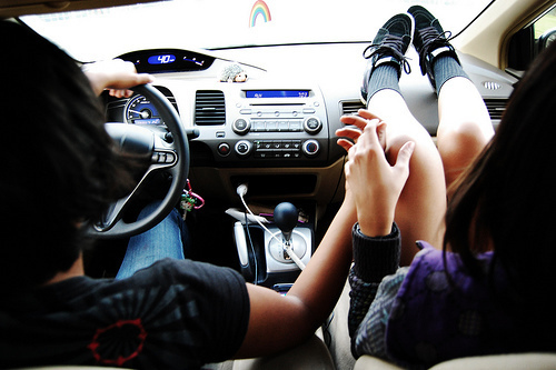влюбленная пара катается на машине девушка положила ноги на приборную доску
