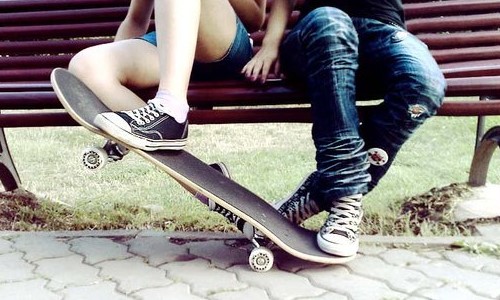 парень с девушкой на скамейке со скейтом