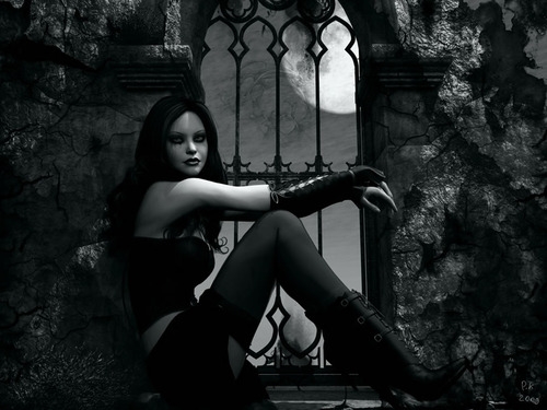 готическая девушка в темноте возле решетки