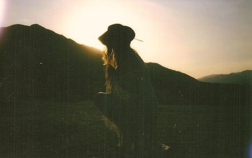 девушка в шляпе возле холмов светит солнце