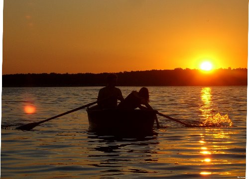 влюбленная пара празднует годовщину в лодке на закате