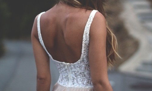 блондинка с загорелыми лопатками в белом платье с голой спиной