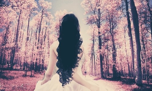 брюнетка с длинными волосами со спины в сказочном лесу